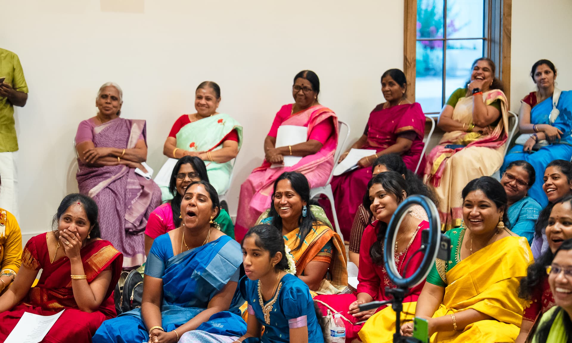 Women and children sharing a joyful community moment