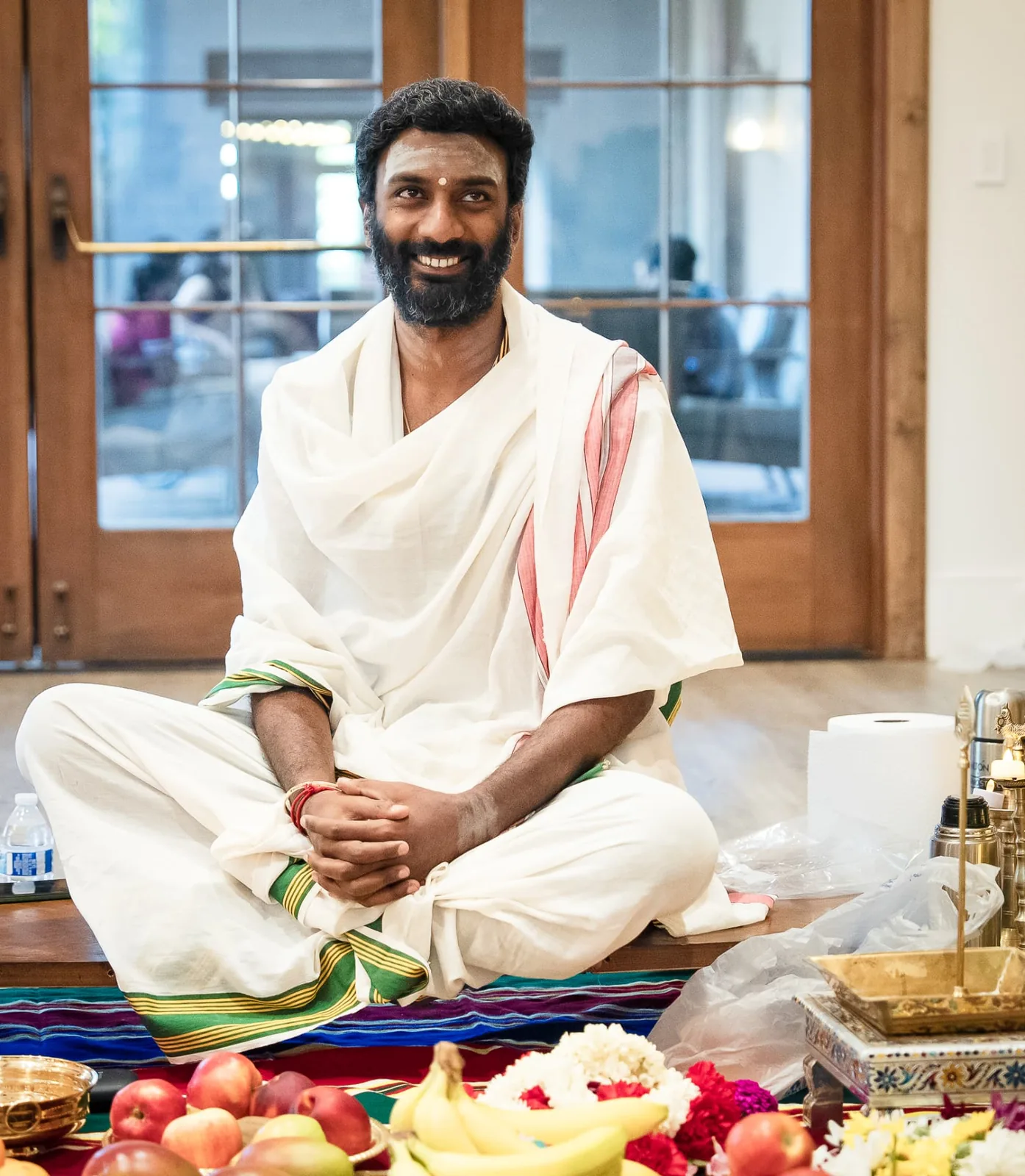 Sri Rama Vijayakumar seated with devotional offerings